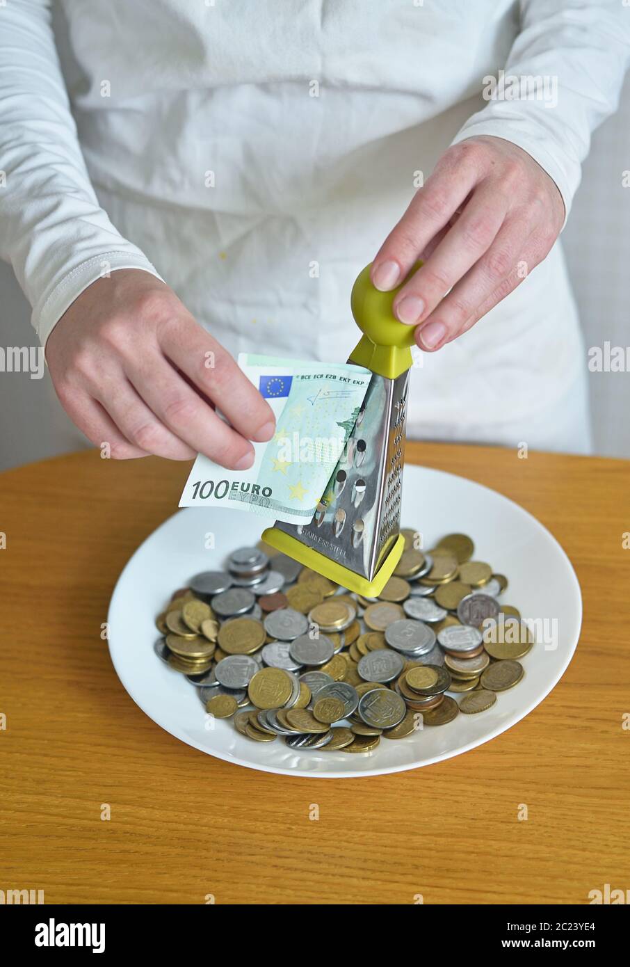exchange euros for cents using a grater Stock Photo