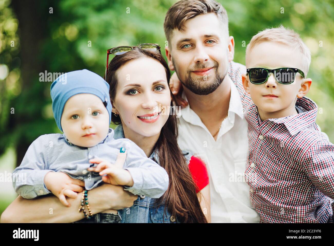 Portrait of young happy family kissing his little son. Stock Photo