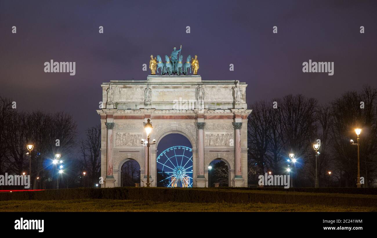 Paris, France - August 04, 2006: Beautiful view of the Arc de Triomphe du Carrousel in the evening against the backdrop of stree Stock Photo