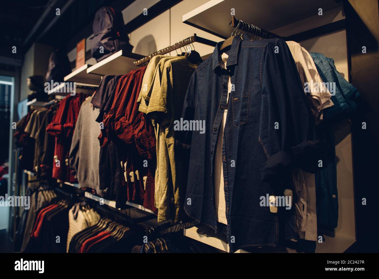 Men clothes store. Stylish men's youth clothes in shopping clothes store.  Shopping concept Stock Photo - Alamy