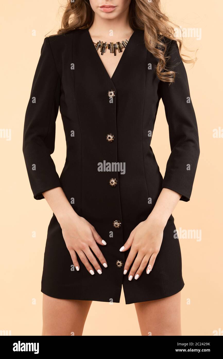 Cropped view of slim lady wearing black dress and posing Stock Photo