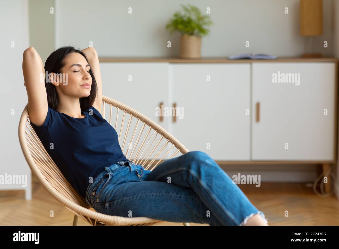 One woman sitting chair eyes closed hi-res stock photography and images ...