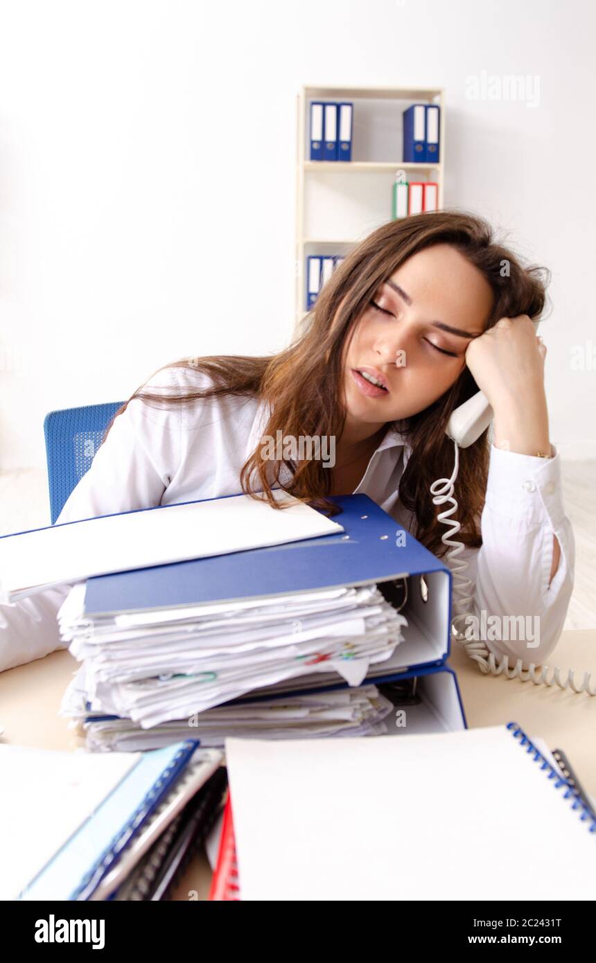 Young female employee unhappy with excessive work Stock Photo