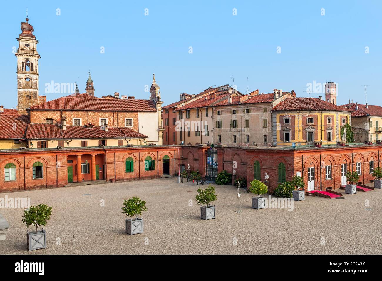 Bell tower among old houses in small town of racconigi in Piedmont, Italy. Stock Photo