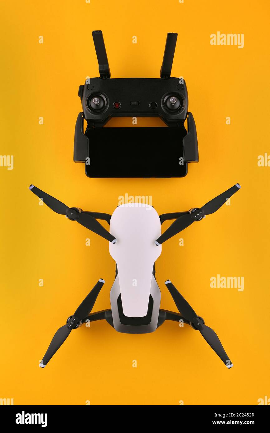 Drone quadcopter with a remote control and a smartphone is ready to fly