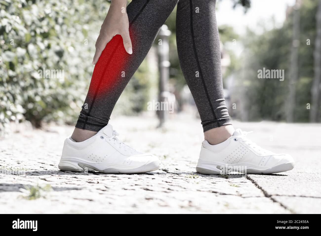 Closeup Of A Female Runner Suffering From Pain In Calf Muscle Stock