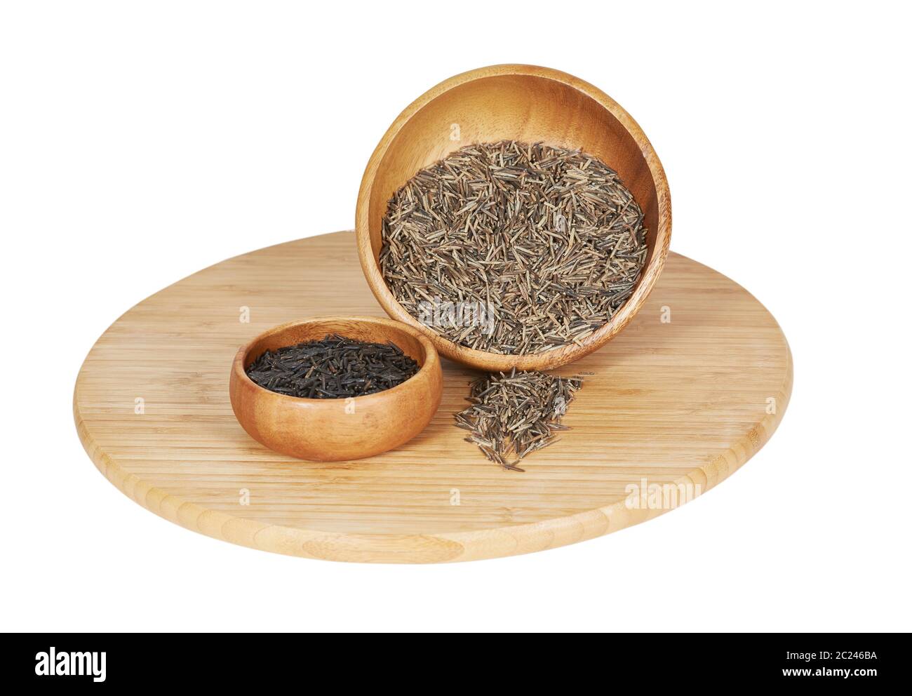 Wooden Bowls filled with two types of wild rice, the one on the left, dark one, is cultivated wild rice, the one of the right is wild grown and hand p Stock Photo