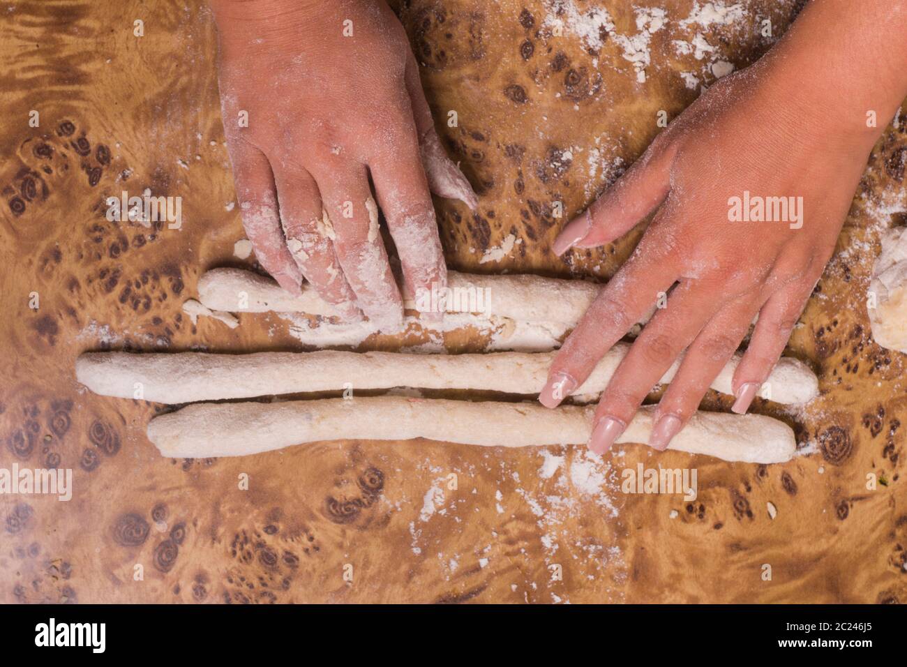 two hands making pasta. hands preparing gnocchi Stock Photo