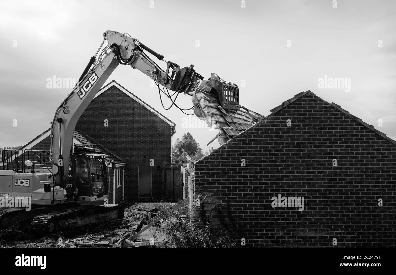 Heavy machinery demolishes private house to make way for development of new Lidl supermarket along Minster Way in Beverley, UK. Stock Photo