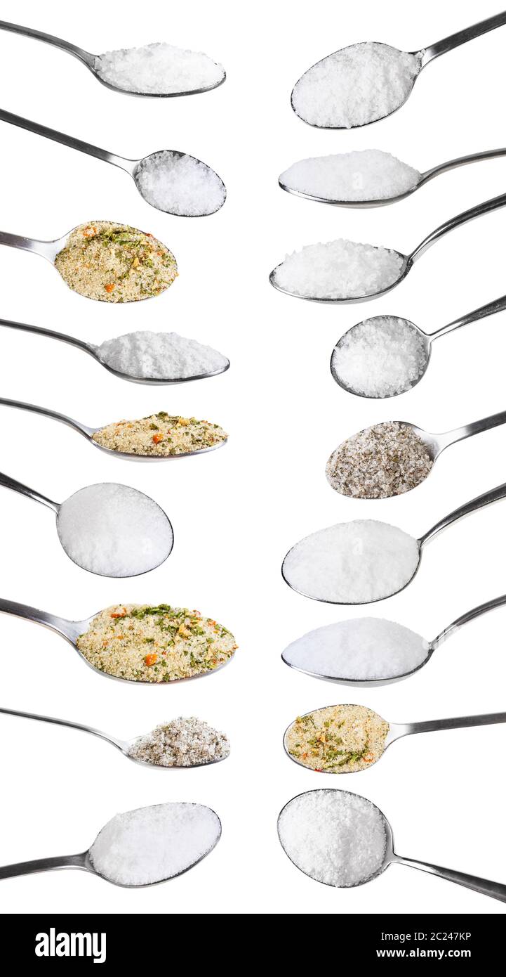 set from steel spoons with various salts isolated on white background Stock Photo