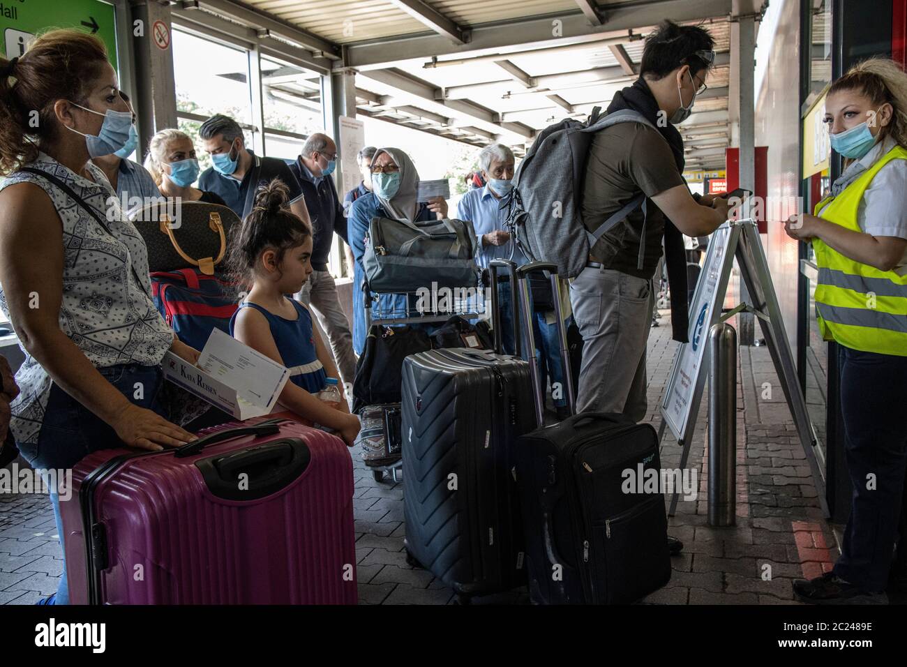 Travellers queuing up outside the Berlin Tegel Airport terminal trying to check-in for flights during the coronavirus COVID 19 restrictions, Germany. Stock Photo