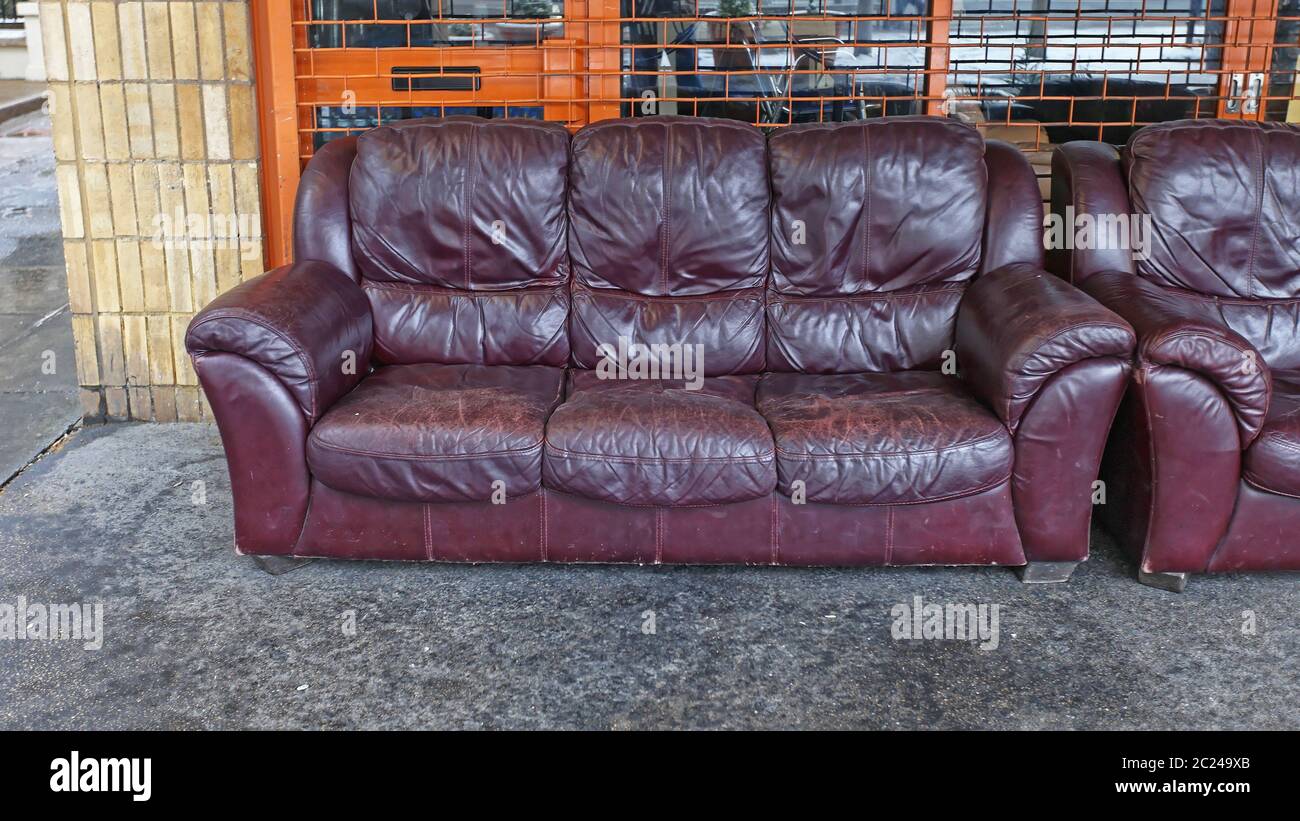 Rejected Old Leather Sofa in Front of Shop Stock Photo - Alamy