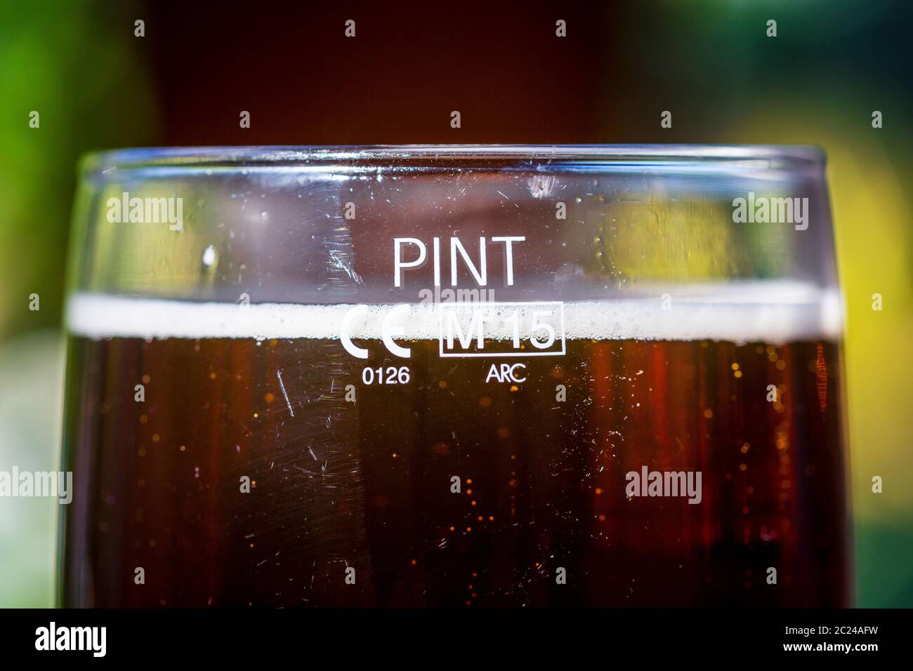 Pint of beer, in a pint glass full to the pint measure. Stock Photo