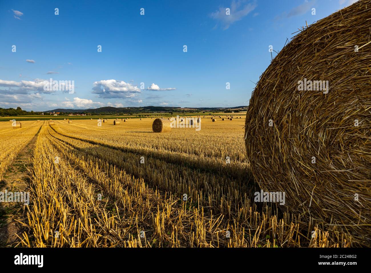 stubble field with straw bale after harvest Stock Photo - Alamy