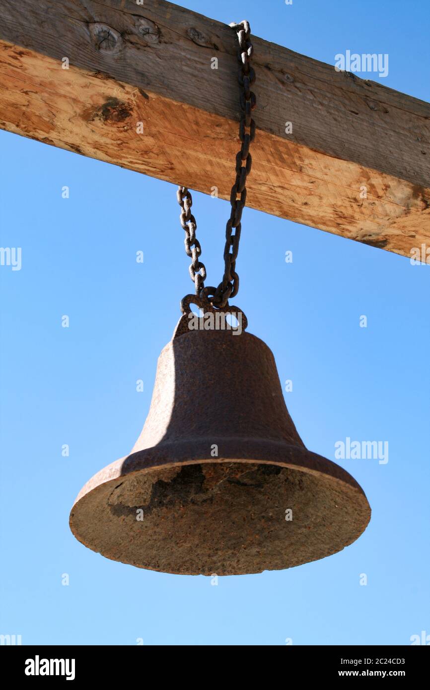 Old bell hangs on gallows Stock Photo