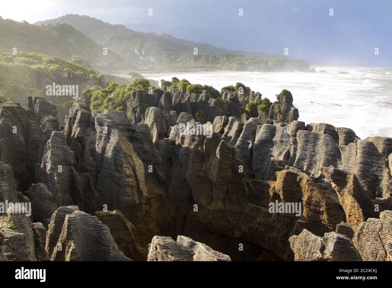 Beautiful light play with strong contrast in the layered rocks of the Pancake Rocks Stock Photo