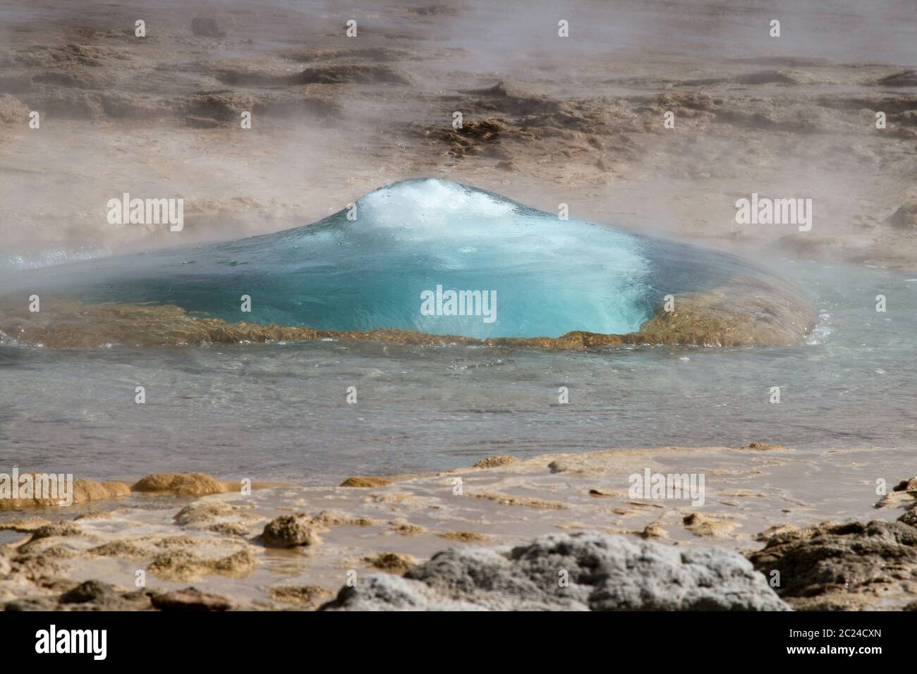 Boiling water shoots out of earth in geyser Stock Photo