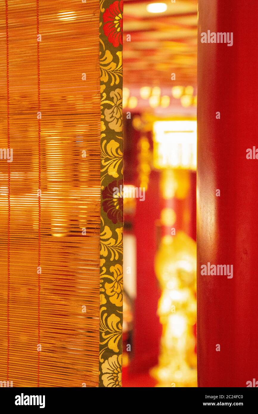 Bamboo curtain overlooking asian temple Stock Photo
