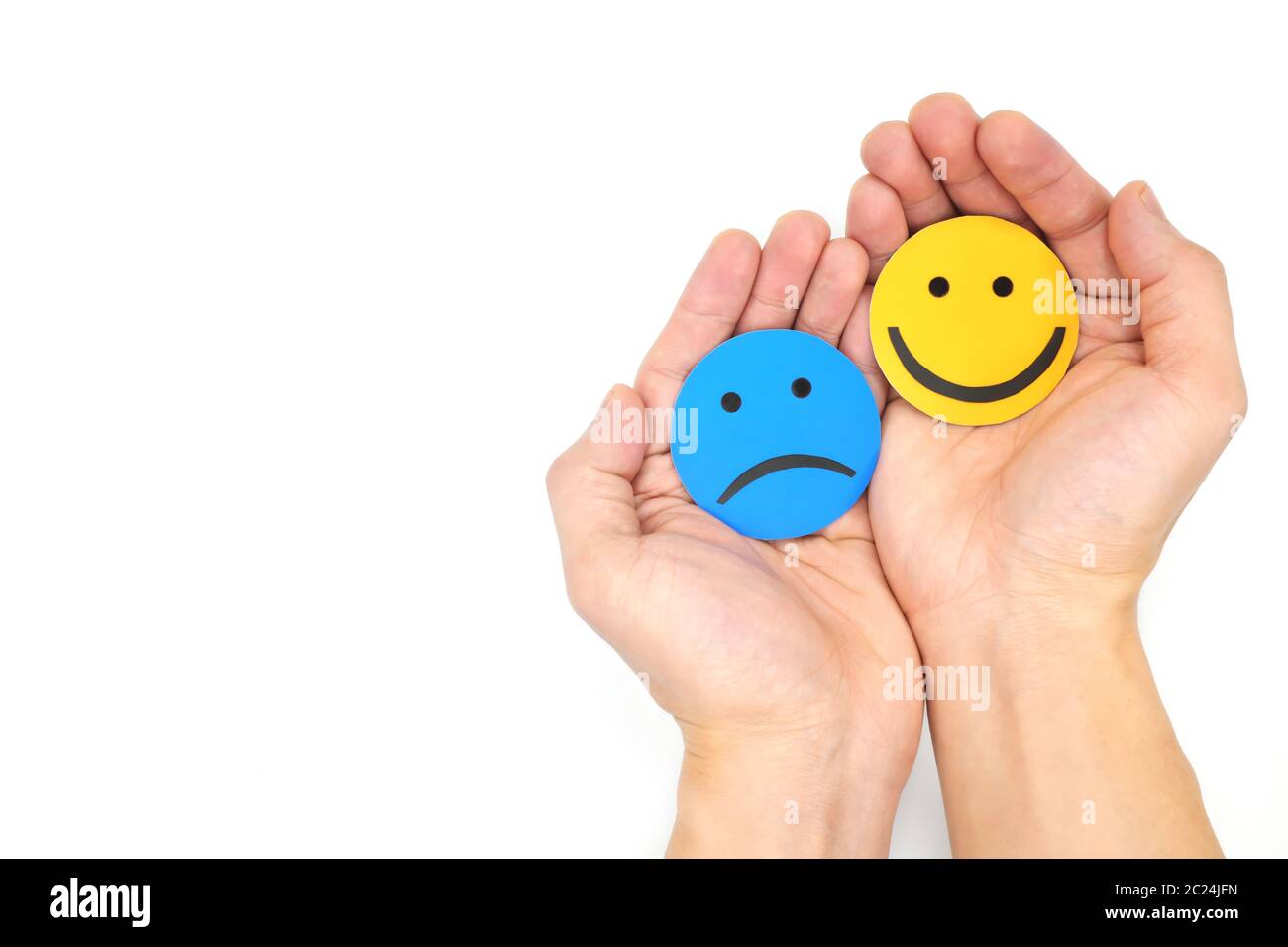 Friendship, sympathy and share happiness concept. Hands holding sad and happy faces hugging each other. Stock Photo