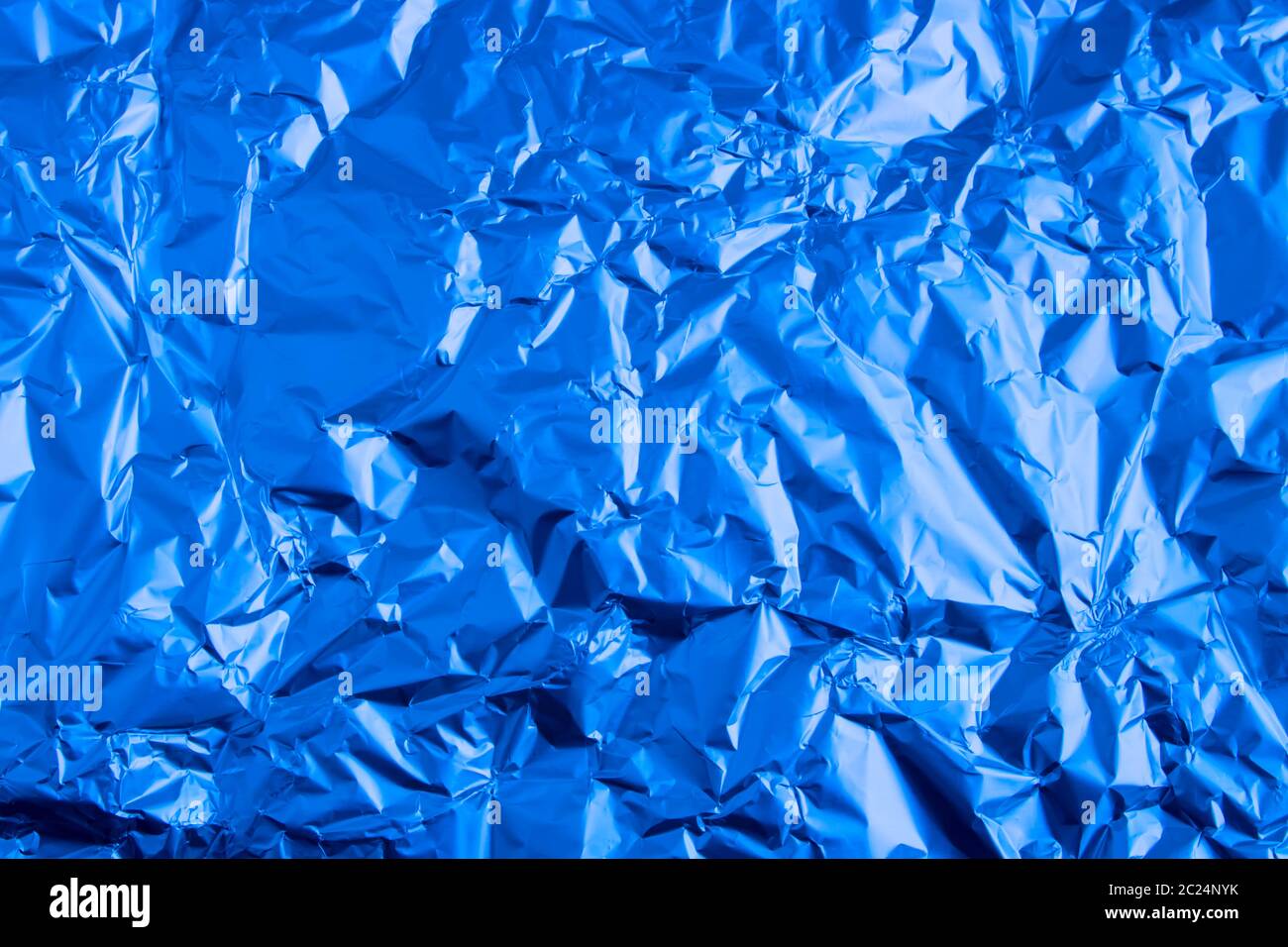 Abstract trendy blue colored crumpled foil texture background. 2020 year color trend concept. Stock Photo