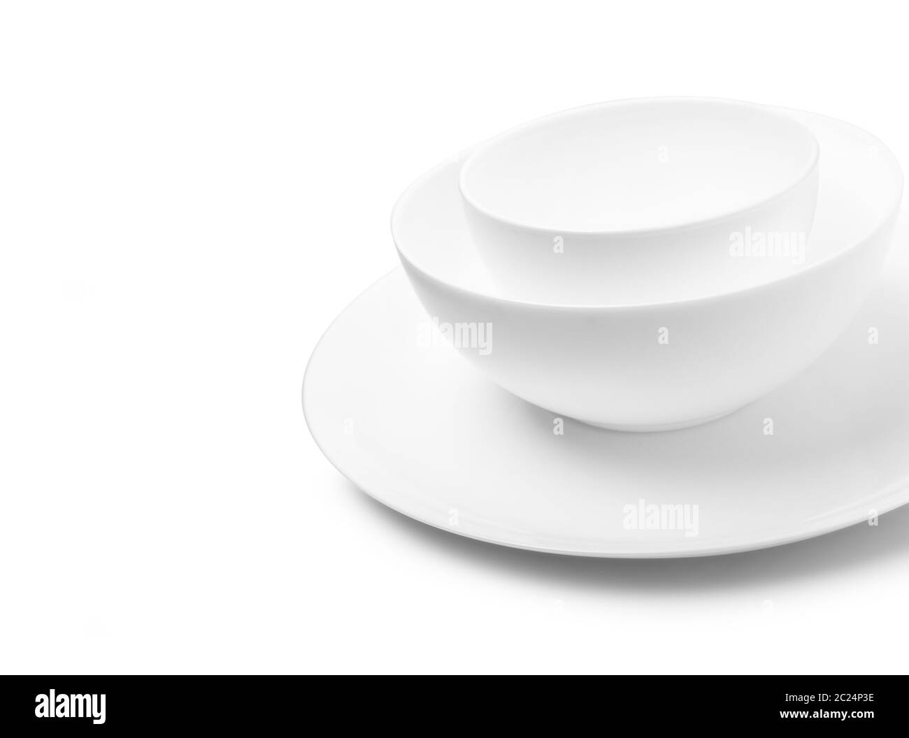 Set of white dishes on table on light background. With clippig path