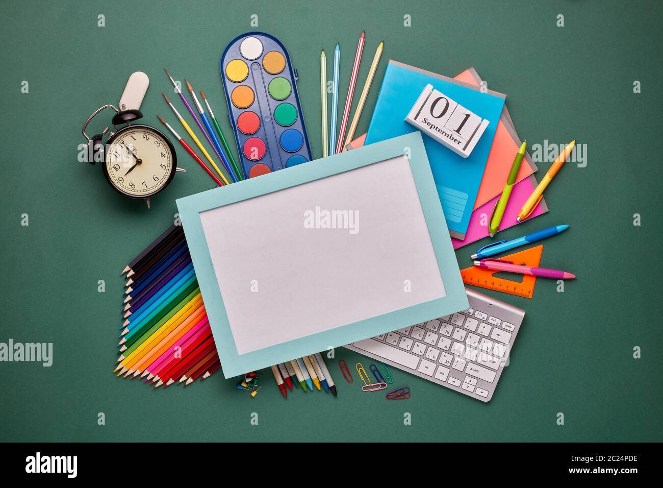 Blue frame with blank sheet, computer keyboard, stationery accessories ...