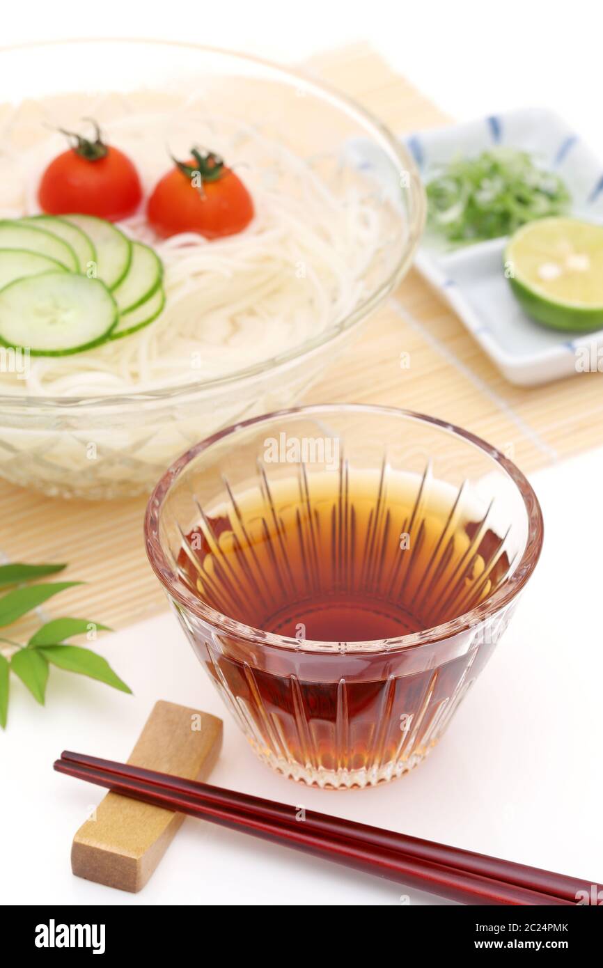 Japanese somen noodles in a glass bowl with soy sauce on white ...