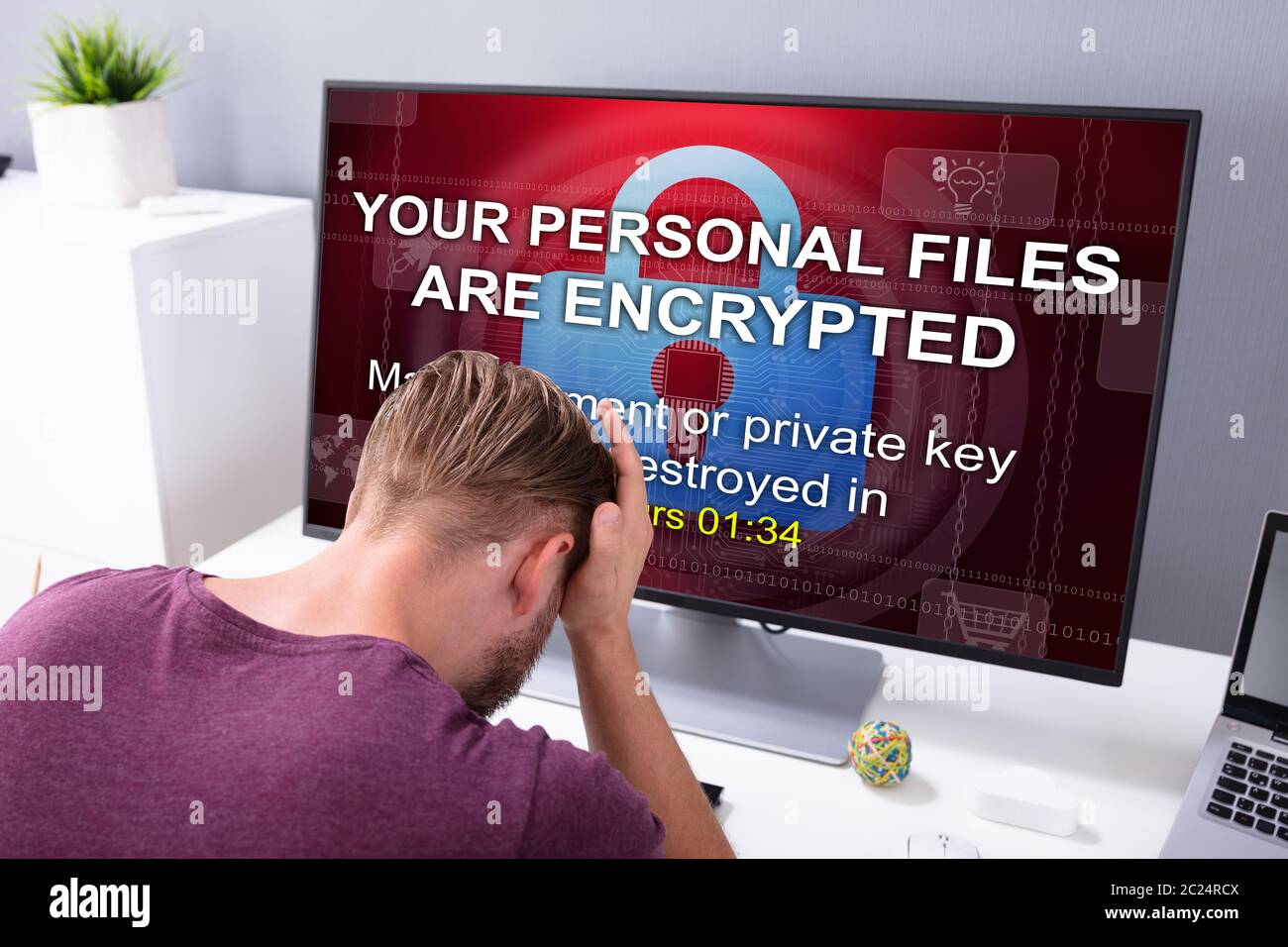 Worried Businessman At Computer With Ransomware Word On The Screen At ...