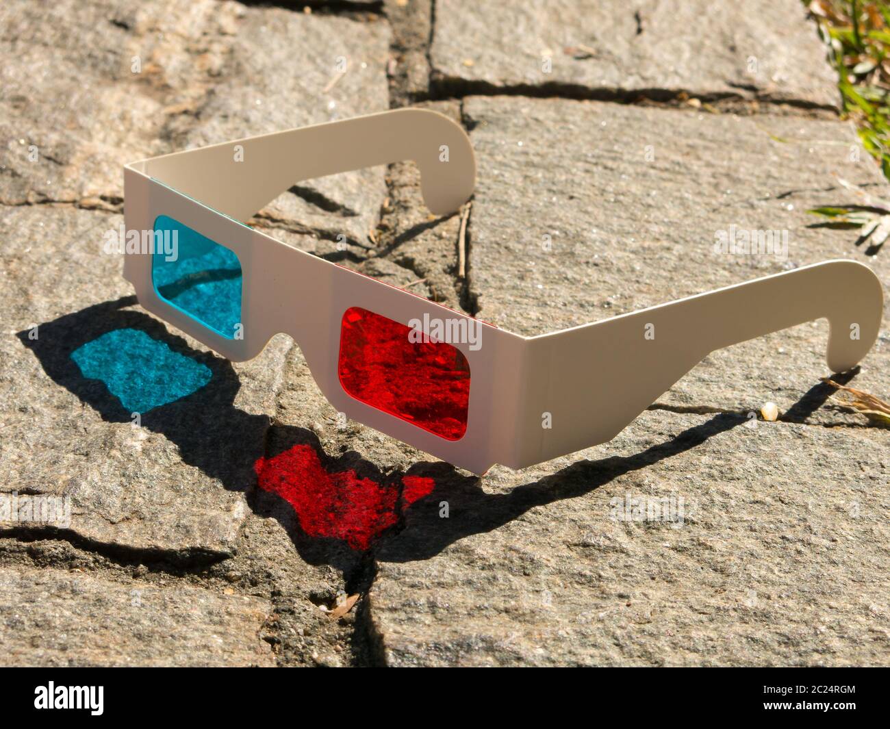 Red cyan stereophotography anaglyph 3D glasses on rocks ground pattern  Stock Photo - Alamy