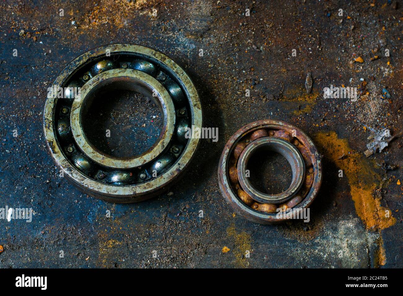 Two old bearing kits rusty and abandoned on a dirty table Stock Photo