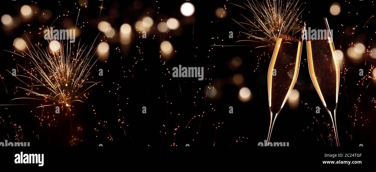 New Year champagne with fireworks on night sky with golden bokeh Stock Photo