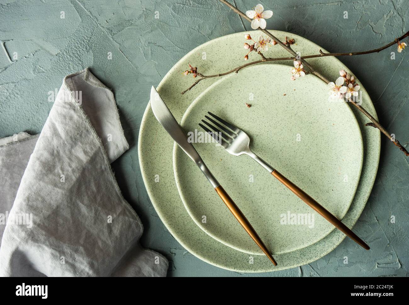 Spring table setting with blooming tree branch Stock Photo