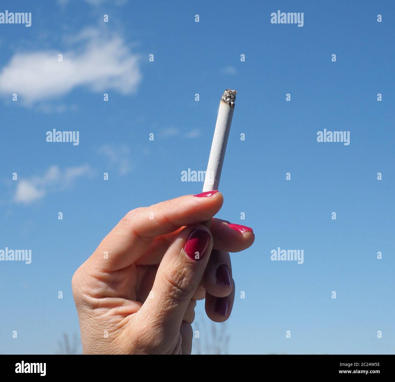 sky blue tobacco cigarette with blue sky Stock Photo