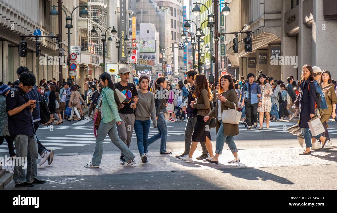 Mass crowd walking across the famous Shibuya pedestrian scramble crossing, Tokyo, Japan. Stock Photo
