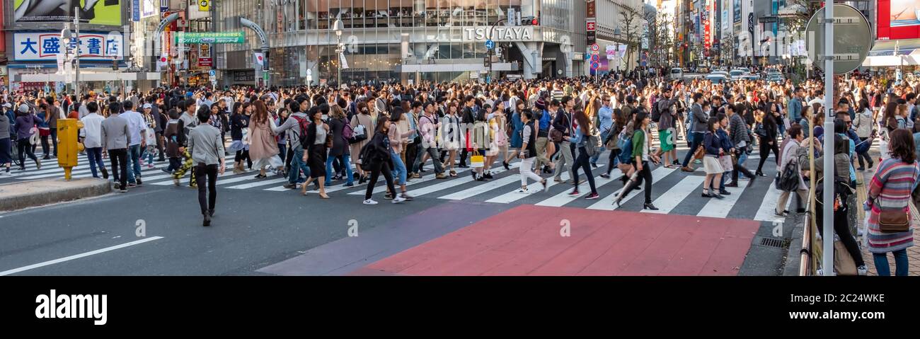 Mass crowd walking across the famous Shibuya pedestrian scramble crossing, Tokyo, Japan. Stock Photo