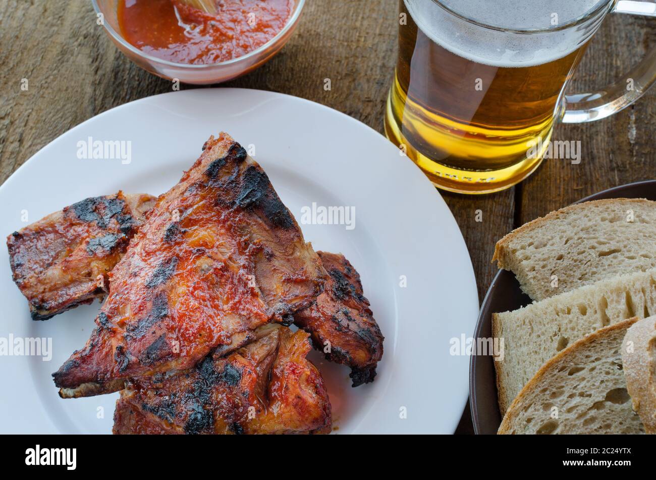 Spareribs on grill with hot marinade, czech beer and bread Stock Photo -  Alamy