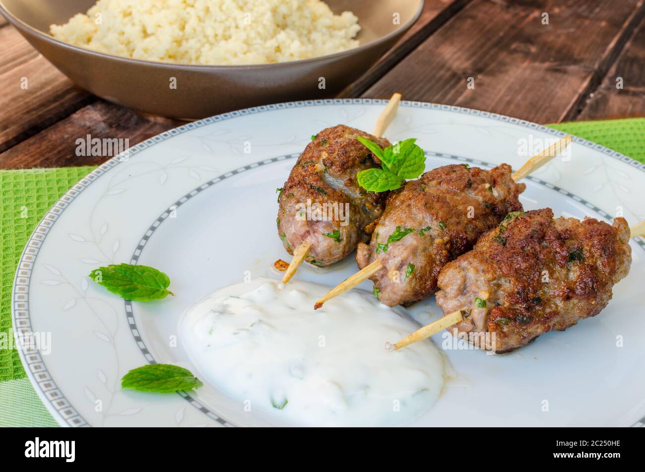 Beef kebab with coriander, garlic, couscous and mint dip Stock Photo Alamy
