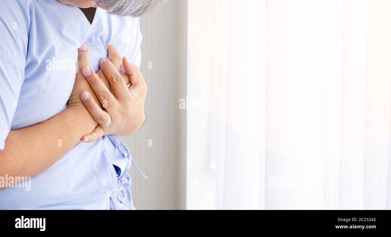 Asian middle age man with chest pain suffering from heart attack in