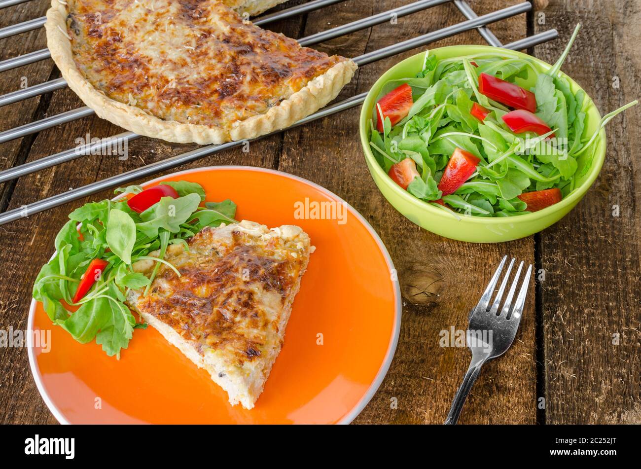 French quiche with cheese and salad paprica arugula Stock Photo Alamy