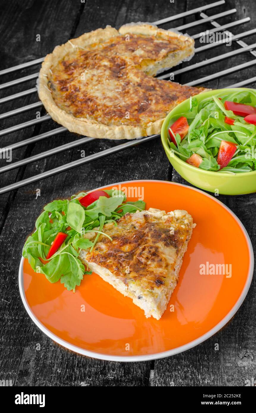 French quiche with cheese and salad paprica arugula Stock Photo Alamy