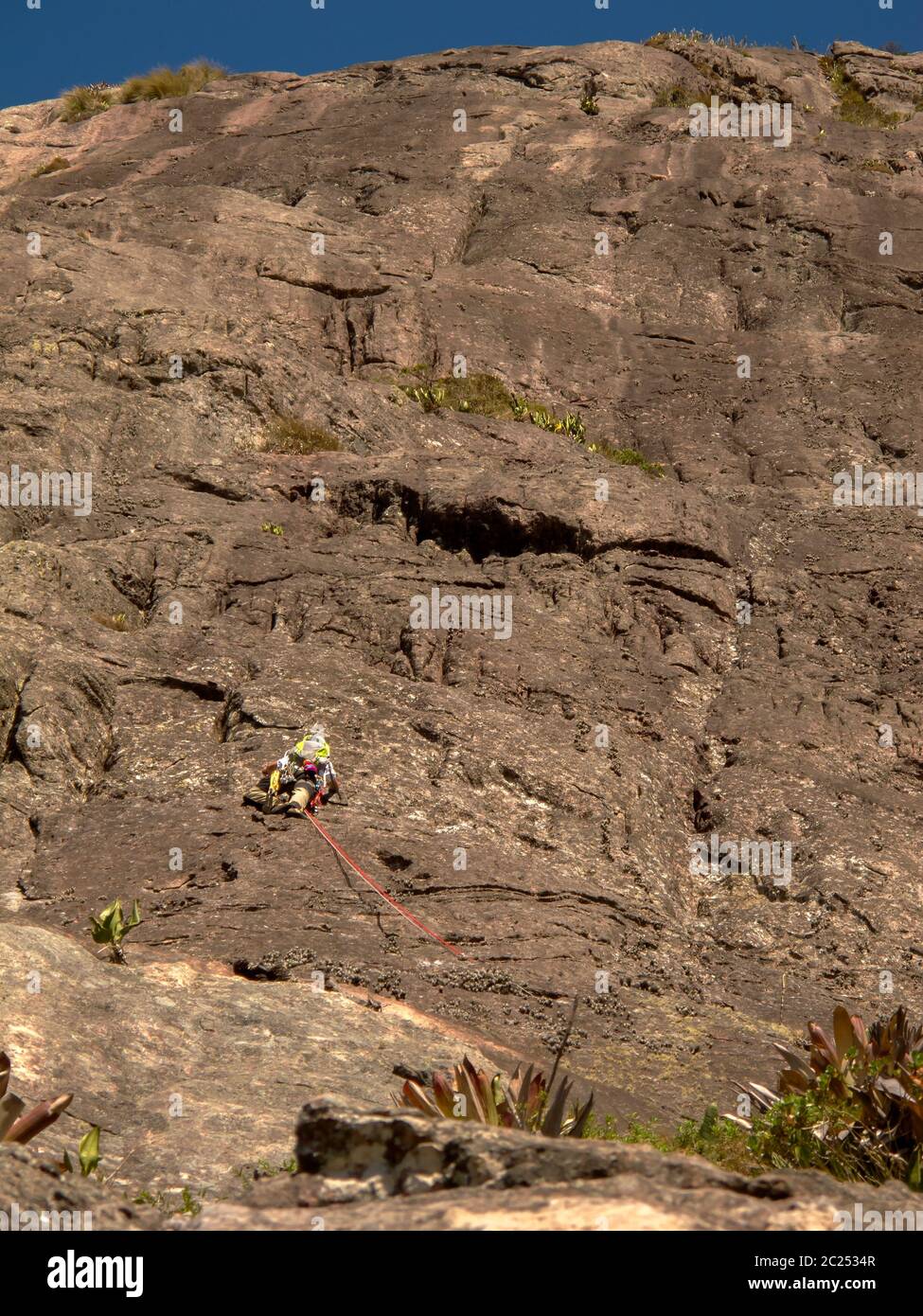 Rock climber climbing a sloping rock wall in Brazil Stock Photo Alamy