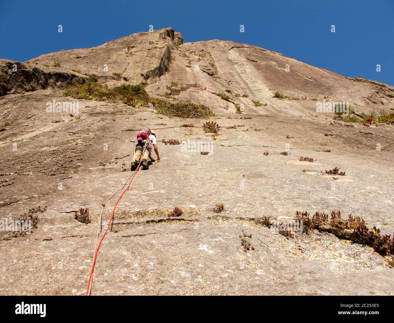 Rock climber climbing a sloping rock wall in Brazil Stock Photo Alamy