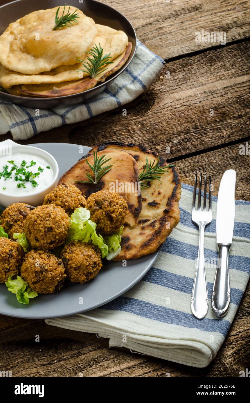 Health crunchy falafel with mint and garlic dip, naan bread with cumin