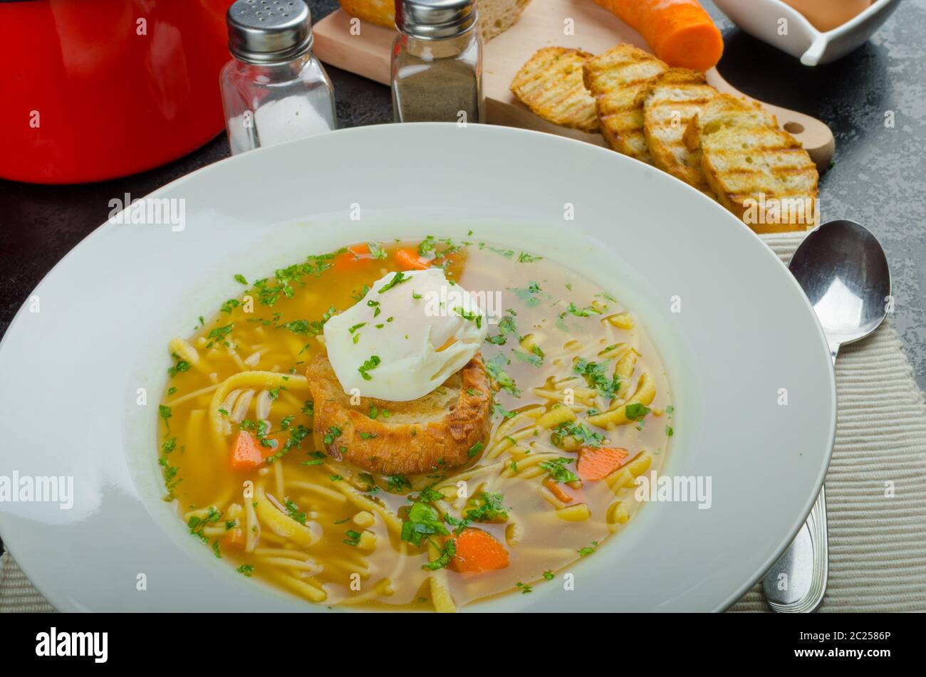 Homemade beef broth, homemade noodles and garlic toast with eggs