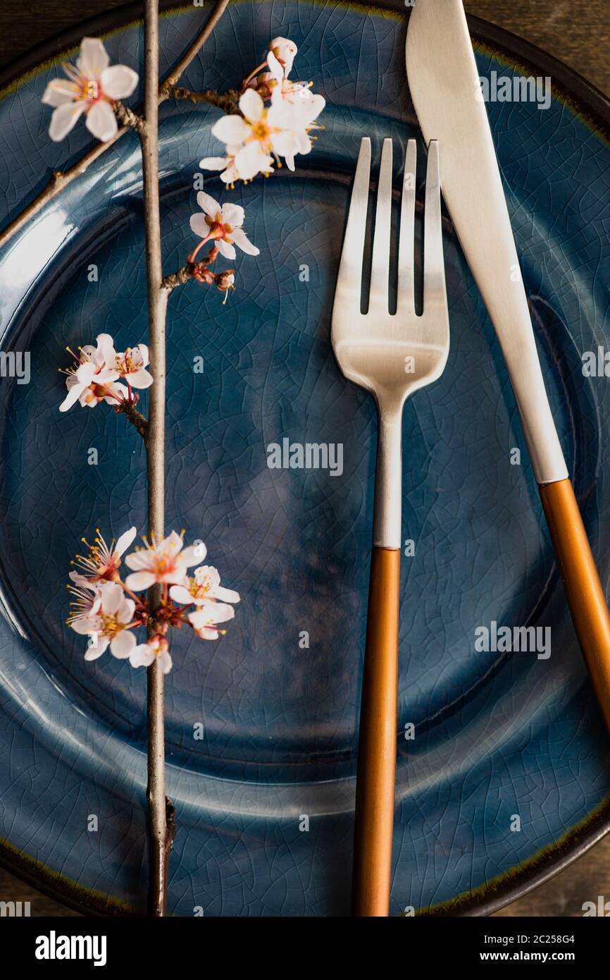 Spring table setting with blooming tree branch Stock Photo