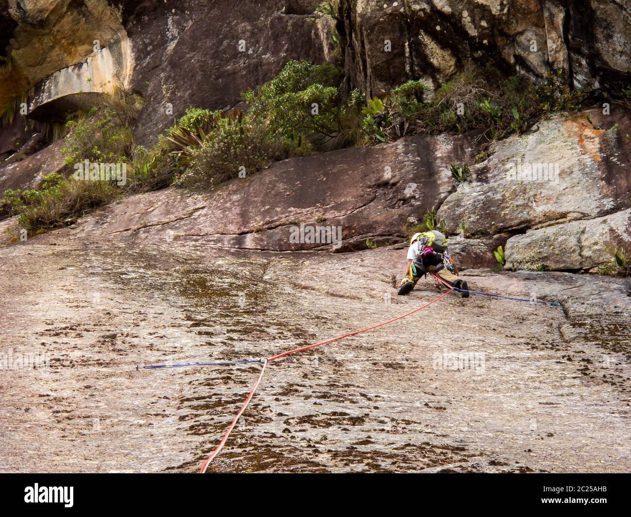 Rock climber climbing a sloping rock wall in Brazil Stock Photo Alamy