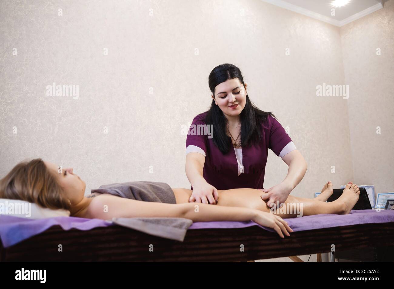 Doctor Specialist Massage Therapist Does Anti Cellulite Massage Of Legs And Buttocks To A Beautiful Young Girl On A Massage Table Health And Beauty Stock Photo Alamy