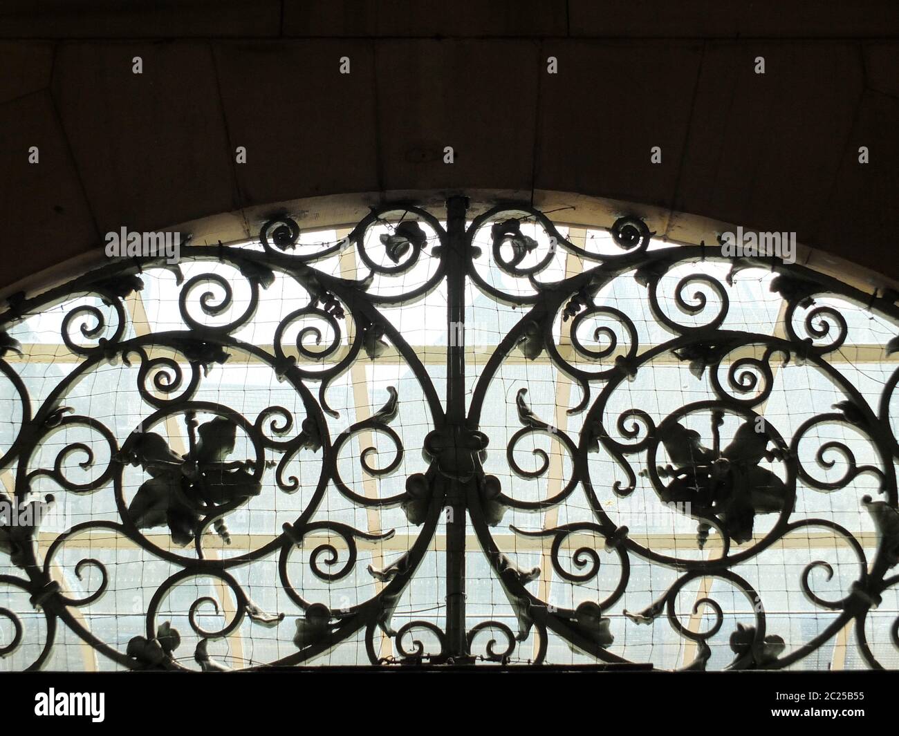 decorative old spiral wrought iron work above a door Stock Photo - Alamy