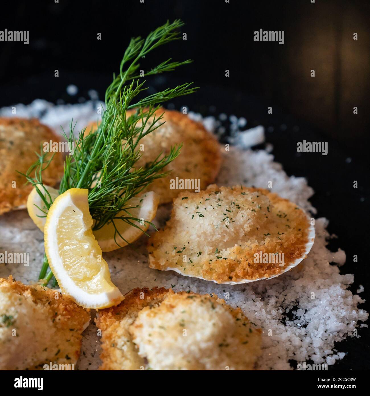 deep fried Hokkaido Scallops Shell with crusty bread serve with lemon and salt designed for square crop using. Stock Photo