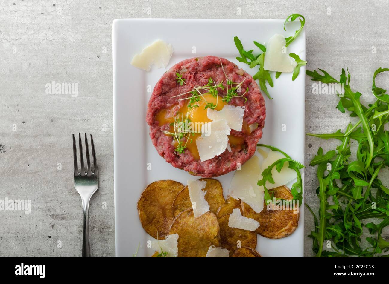 Beef Tartar Homemade Potato Chips Sprinkled With Parmesan Shavings And Microgreens Stock Photo Alamy